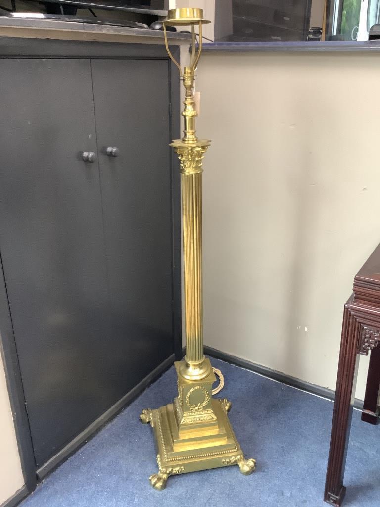 An early 20th century adjustable brass corinthian column lamp standard, minimum height 150cm